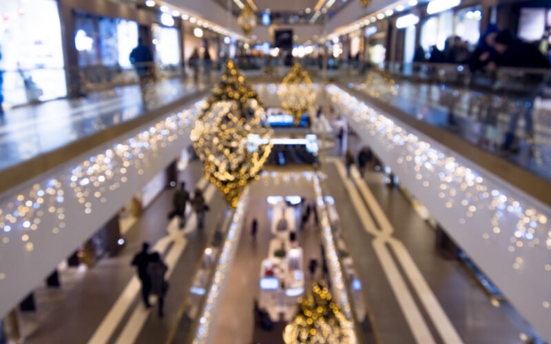 Time of Christmas sales, shopping center, festively decorated. blurred background Time of a Christmas sales, shopping center, festively decorated. blurred background